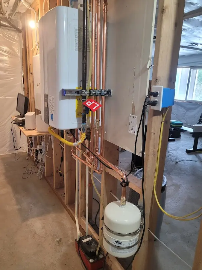 Licensed plumber repairing a kitchen sink in Mount Airy